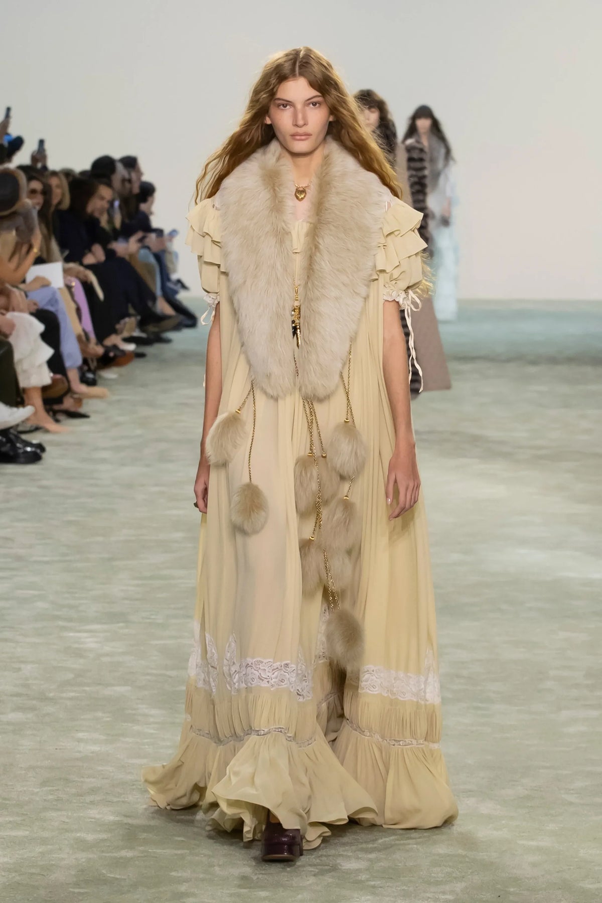 Model walking Chloé FW25 runway in yellow boho maxi dress
