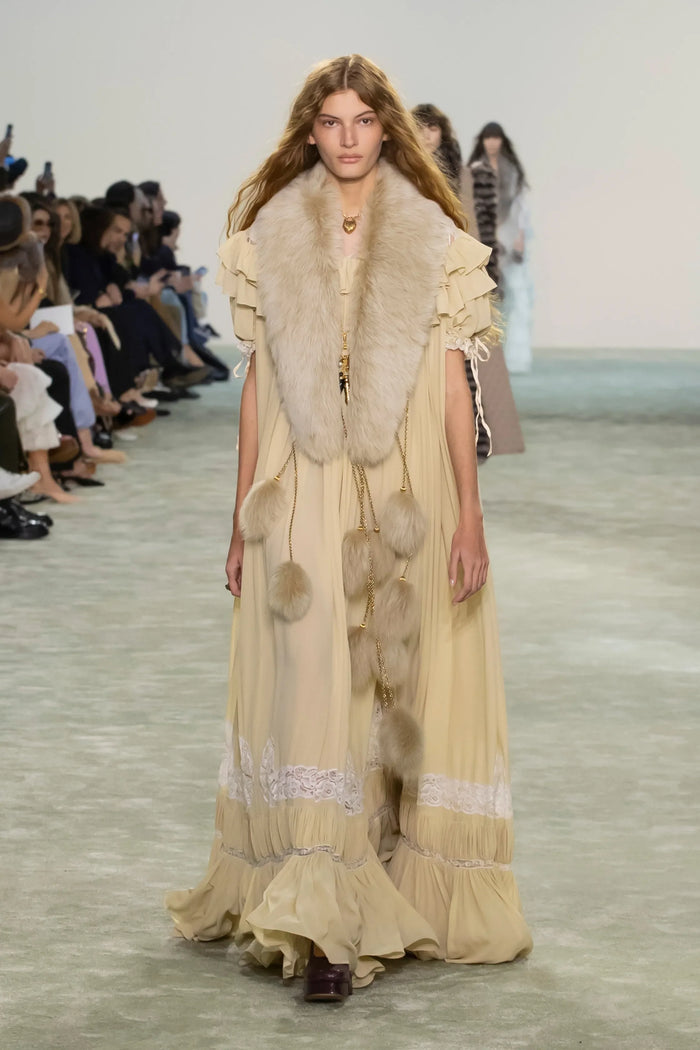 Model walking Chloé FW25 runway in yellow boho maxi dress